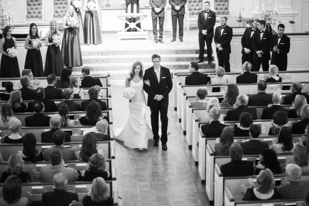 Alex and Taylor walking down aisle One Year Anniversary