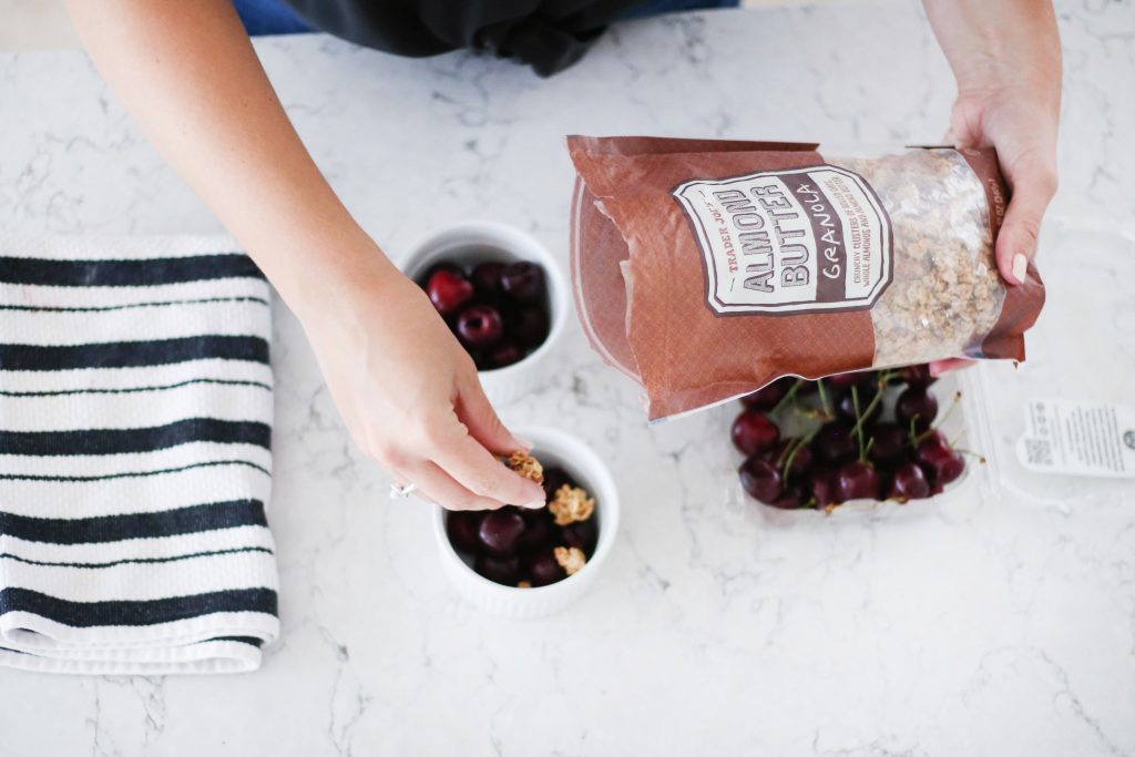 adding Trader Joe's Almond Butter Granola to cherries 